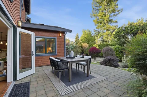 a view of house with backyard outdoor seating and green space