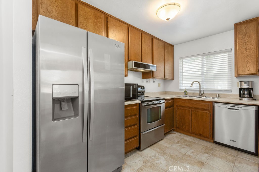 34014 Selva Road Dana Point, CA 92629 - Photo 4 of 10 a kitchen with a refrigerator sink and cabinets