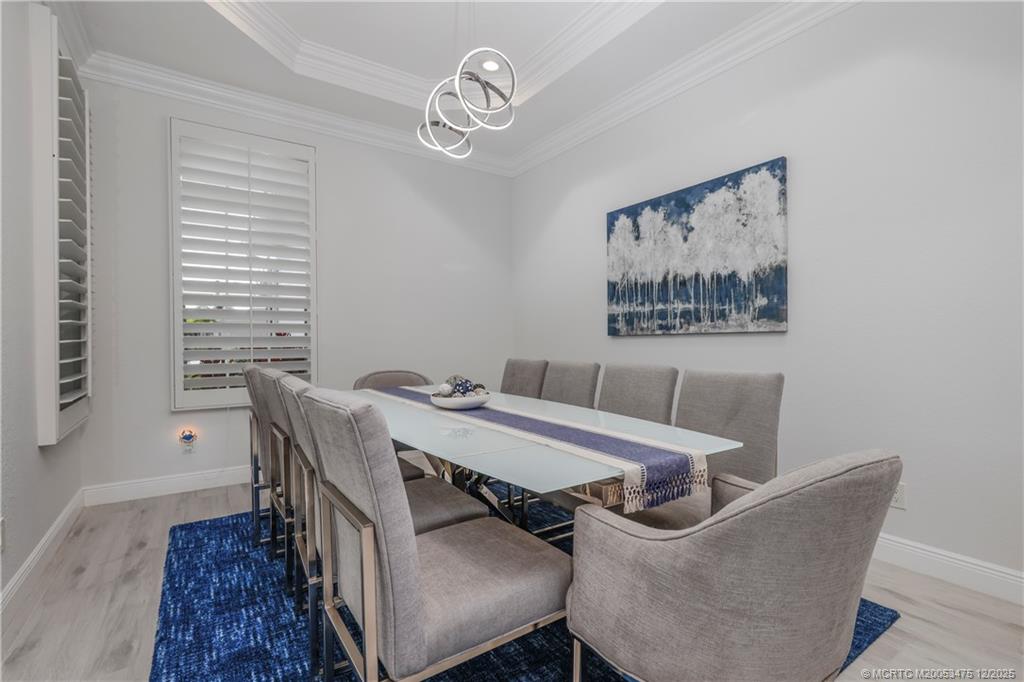 467 Southwest Lost River Road Stuart, FL 34997 - Photo 11 of 65 a view of a dining room with furniture and wooden floor