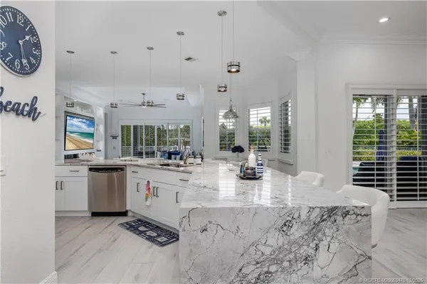 a kitchen with stainless steel appliances granite countertop white cabinets sink and stove