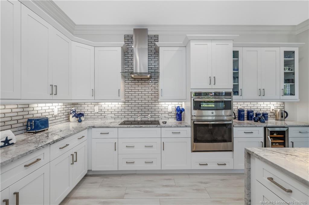 467 Southwest Lost River Road Stuart, FL 34997 - Photo 17 of 65 a kitchen with stainless steel appliances granite countertop white cabinets sink and stove