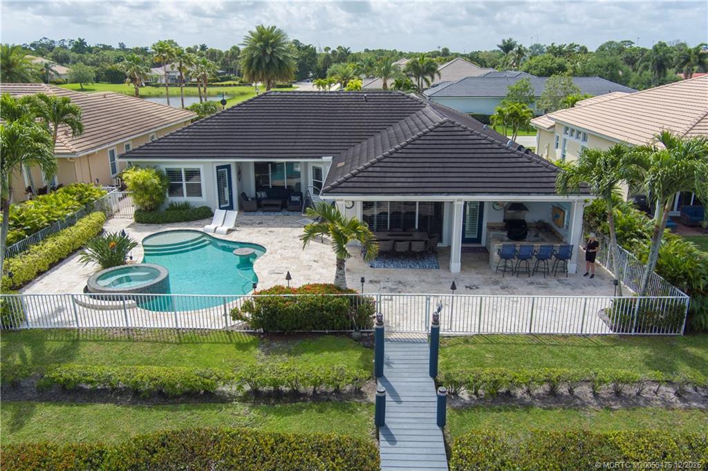 467 Southwest Lost River Road Stuart, FL 34997 - Photo 2 of 65 an aerial view of a house with a yard table and chairs