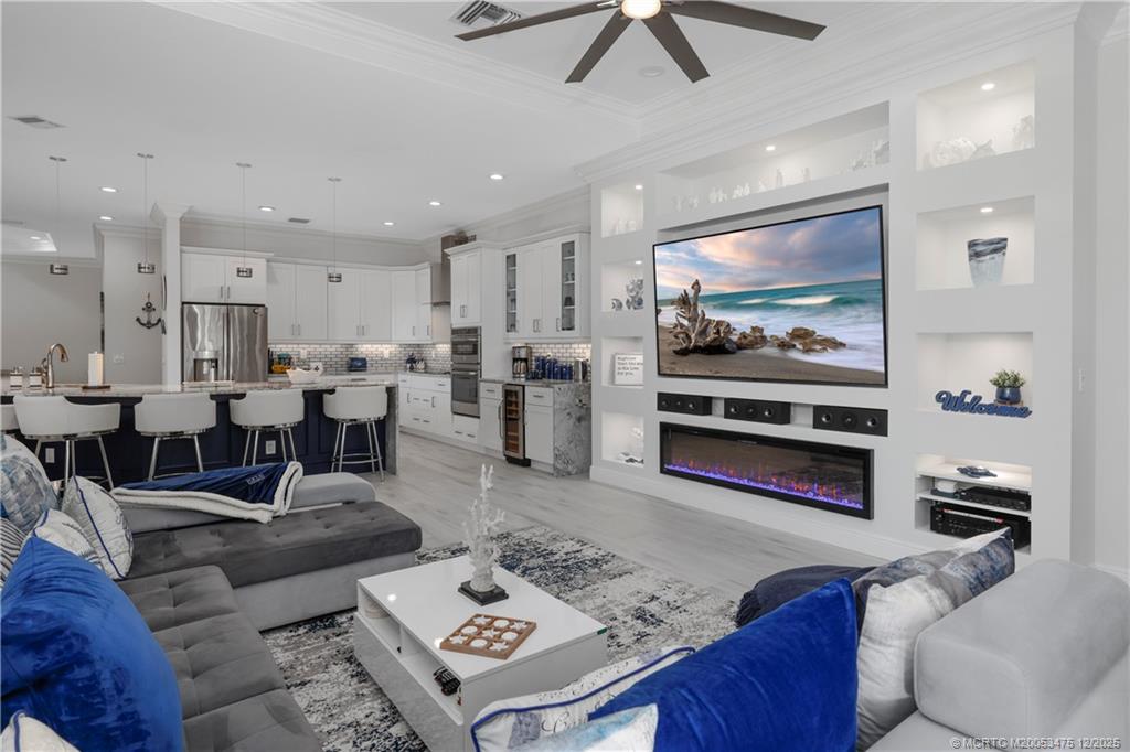 467 Southwest Lost River Road Stuart, FL 34997 - Photo 23 of 65 a living room with furniture and a flat screen tv