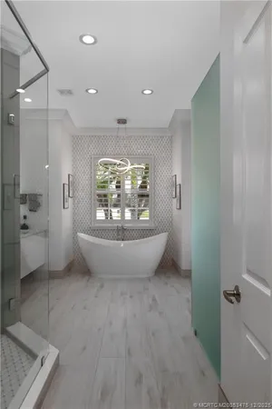 a spacious bathroom with a granite countertop sink mirror and shower