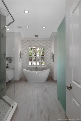 a spacious bathroom with a granite countertop sink mirror and shower