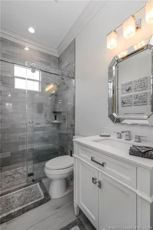 a view of a house with backyard sitting area and a garden