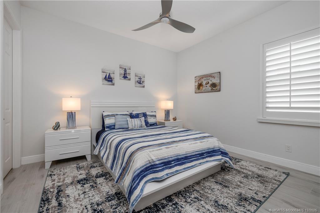 467 Southwest Lost River Road Stuart, FL 34997 - Photo 33 of 65 a bedroom with a bed and a window