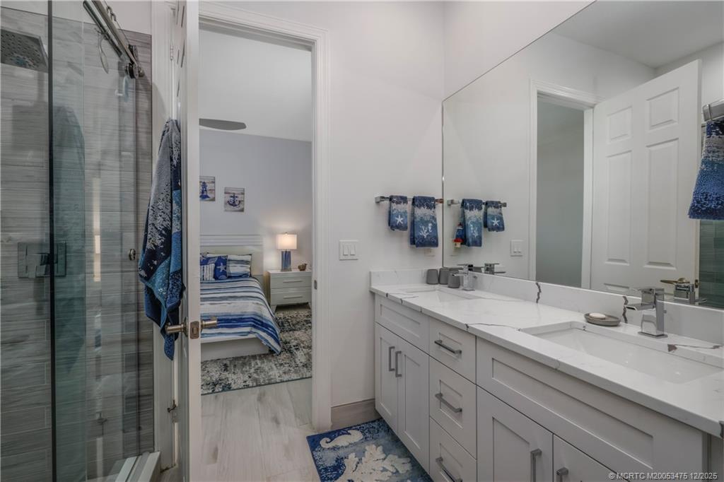 467 Southwest Lost River Road Stuart, FL 34997 - Photo 34 of 65 a spacious bathroom with a granite countertop sink mirror and shower