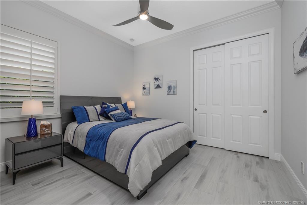 467 Southwest Lost River Road Stuart, FL 34997 - Photo 36 of 65 a bed room with a bed and a chair