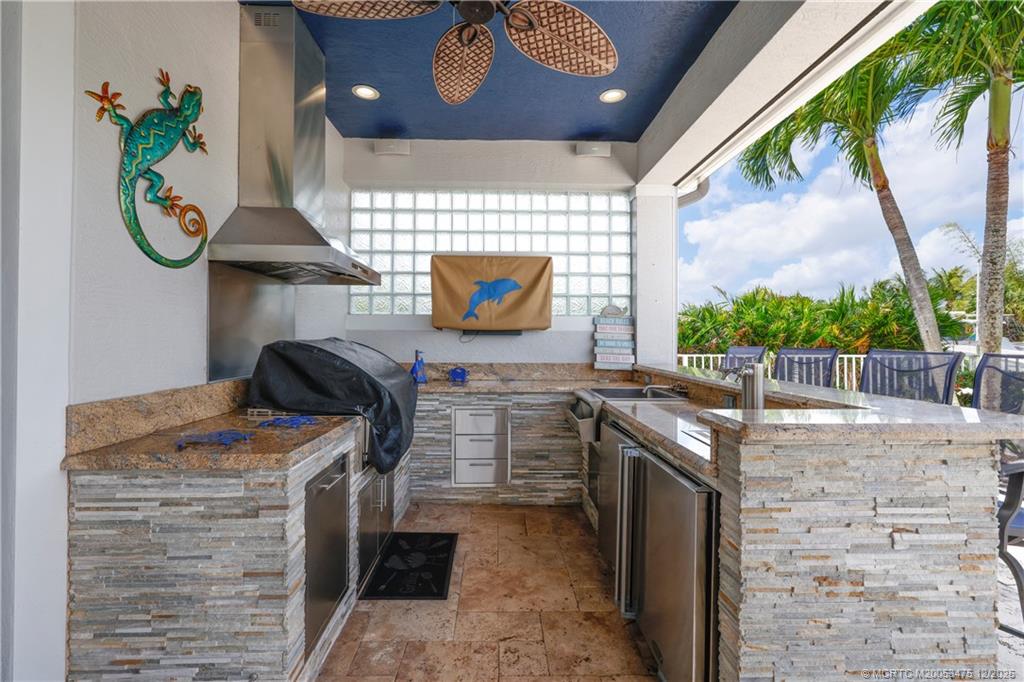 467 Southwest Lost River Road Stuart, FL 34997 - Photo 39 of 65 a kitchen with a refrigerator and a stove