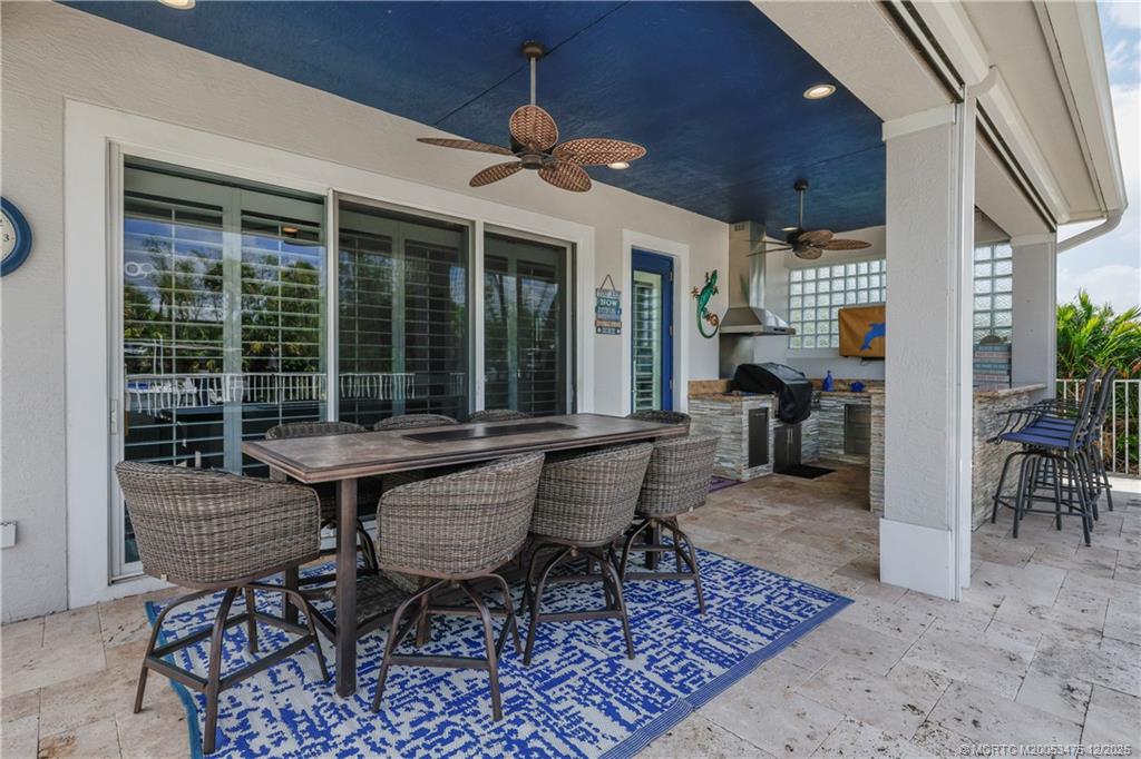 467 Southwest Lost River Road Stuart, FL 34997 - Photo 41 of 65 a view of a dinning table and chair in the patio