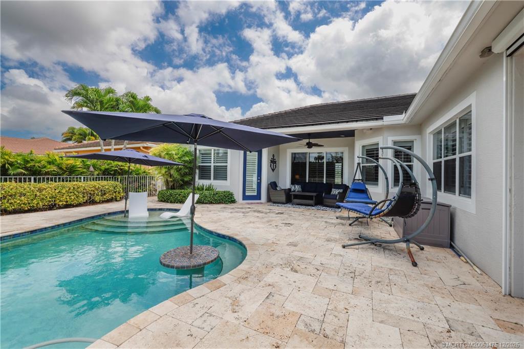 467 Southwest Lost River Road Stuart, FL 34997 - Photo 42 of 65 a view of a house with backyard sitting area and a garden