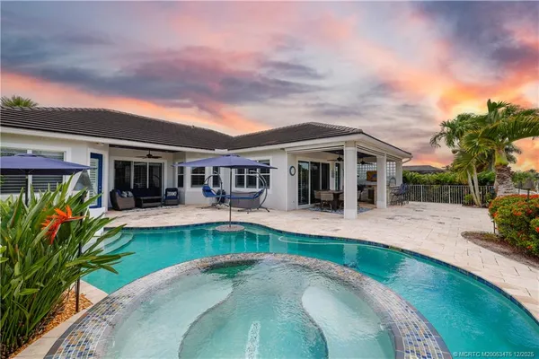 an aerial view of a house with yard swimming pool and outdoor seating