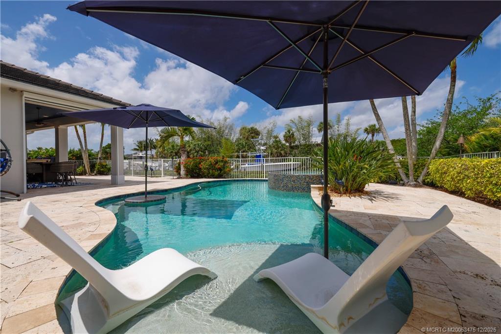 467 Southwest Lost River Road Stuart, FL 34997 - Photo 44 of 65 a view of a swimming pool with a patio