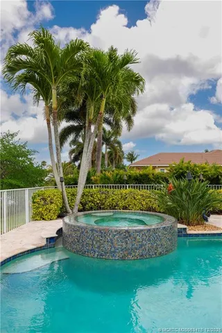 an aerial view of a house with a yard and a swimming pool