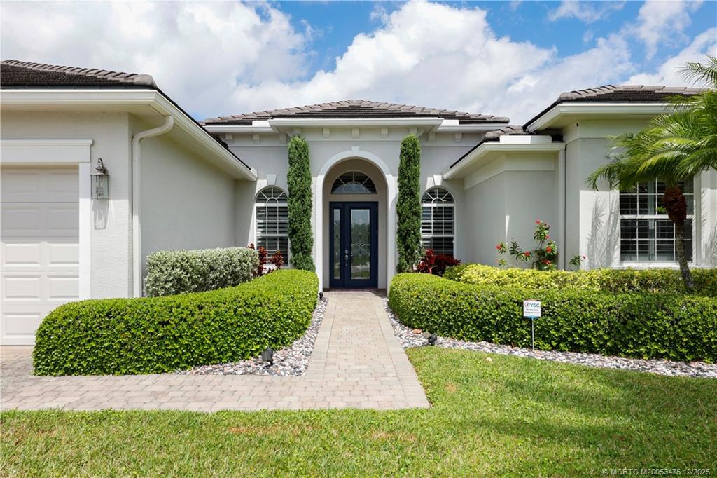 467 Southwest Lost River Road Stuart, FL 34997 - Photo 6 of 65 a front view of a house with garden