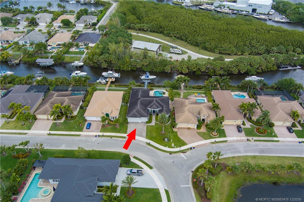 467 Southwest Lost River Road Stuart, FL 34997 - Photo 61 of 65 an aerial view of a house with a yard and lake