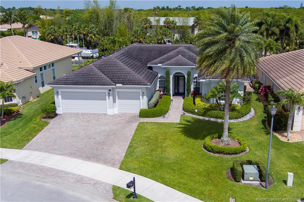 467 Southwest Lost River Road Stuart, FL 34997 - Photo 63 of 65 a house with garden in front of it