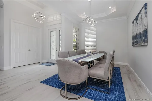 a view of a dining room with furniture and wooden floor