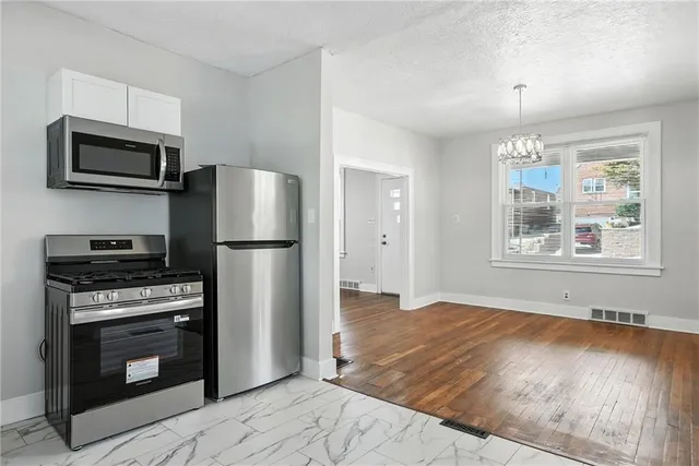 a kitchen with a refrigerator stove and microwave