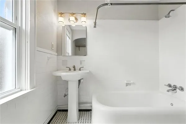 a bathroom with a sink a mirror and a bathtub