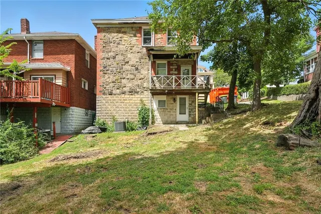 a backyard of a house with yard and barbeque oven
