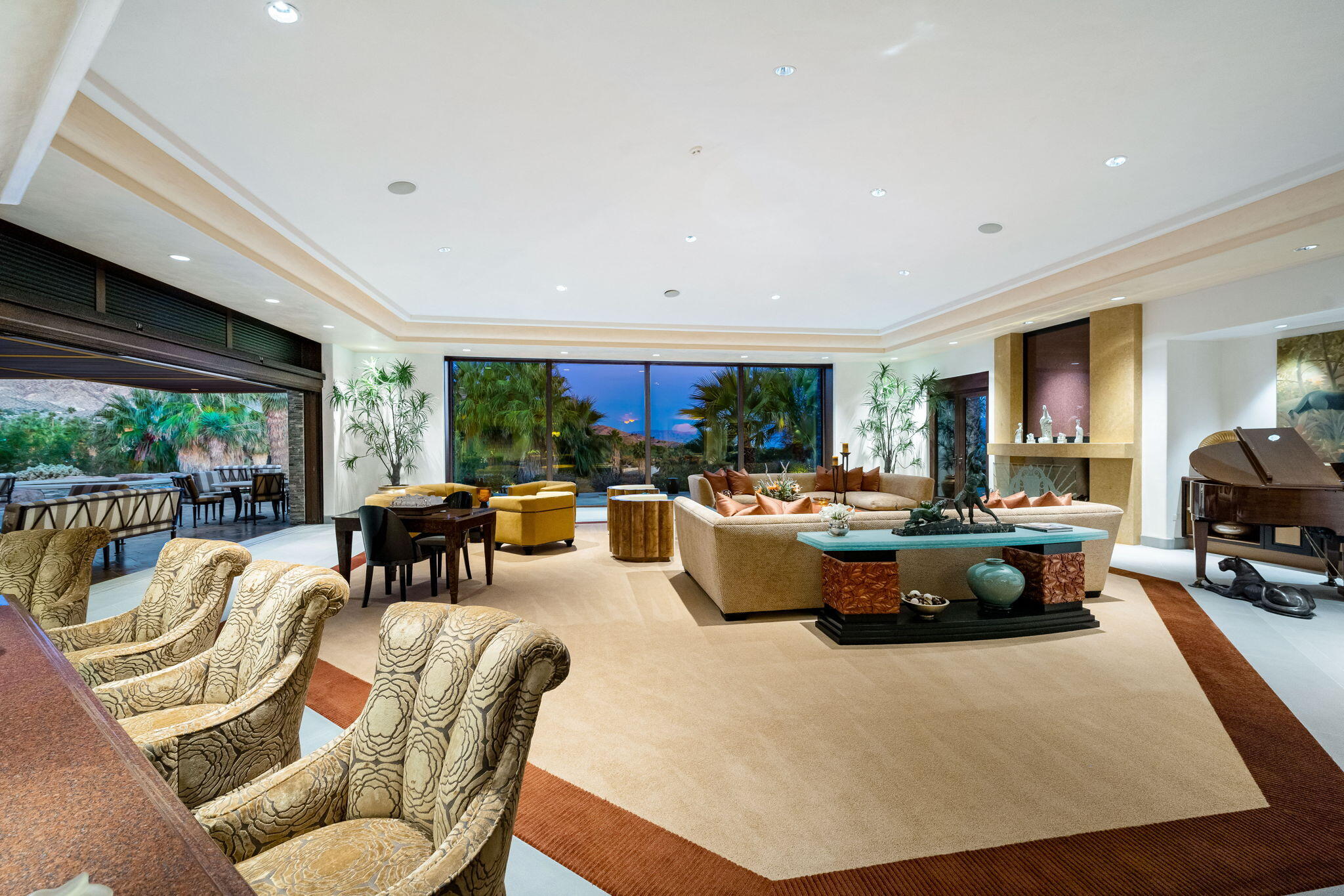 100 Lantana View Palm Desert, CA 92260 - Photo 102 of 121 a living room with furniture a fireplace and a large window