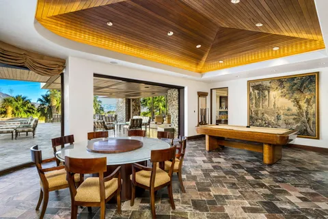 a bedroom with a large bed and a large mirror