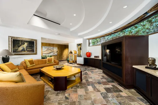 a spacious bedroom with a large bed and a flat tv screen