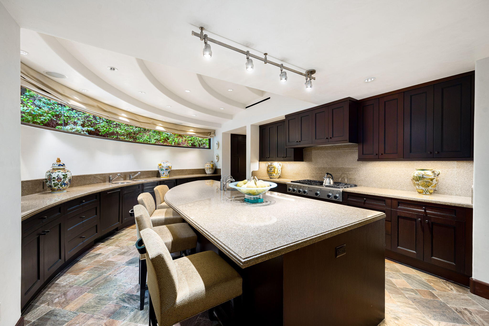 100 Lantana View Palm Desert, CA 92260 - Photo 24 of 121 a kitchen with a stove a sink dishwasher and a refrigerator with wooden cabinets