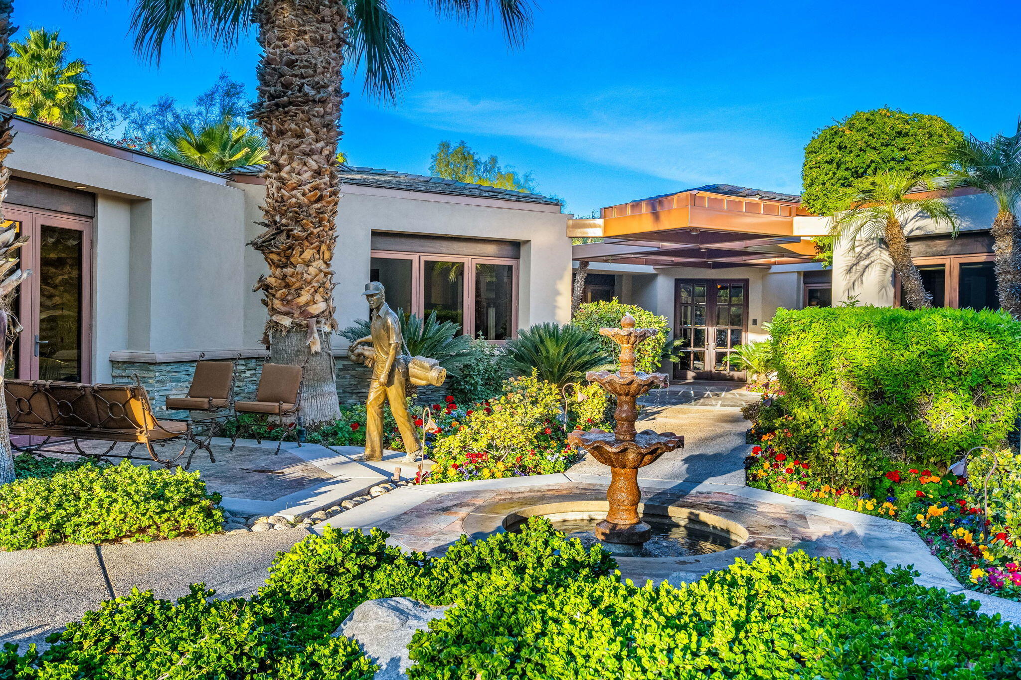 100 Lantana View Palm Desert, CA 92260 - Photo 3 of 121 a front view of a house with yard and outdoor seating