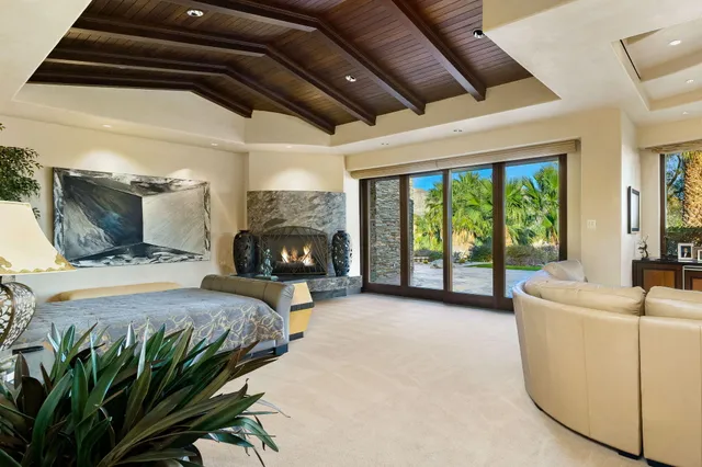 a backyard of a house with table and chairs plants
