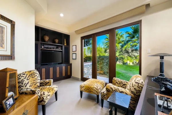 a backyard of a house with table and chairs