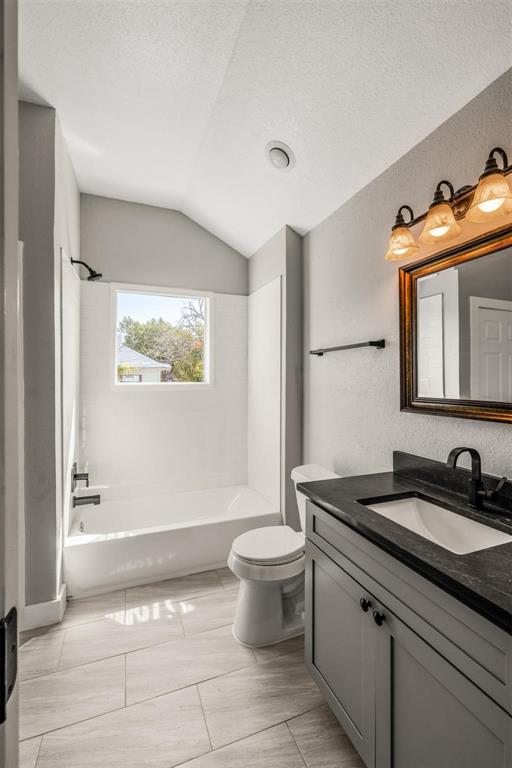 700 North Church Street Decatur, TX 76234 - Photo 11 of 15 a spacious bathroom with a granite countertop sink a toilet and a mirror