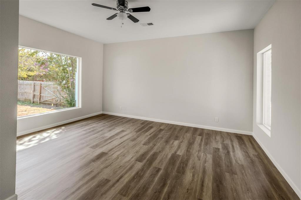 700 North Church Street Decatur, TX 76234 - Photo 12 of 15 wooden floor in an empty room with a window