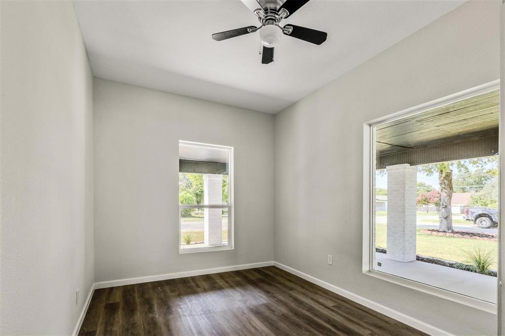 700 North Church Street Decatur, TX 76234 - Photo 13 of 15 a view of an empty room with wooden floor and a window
