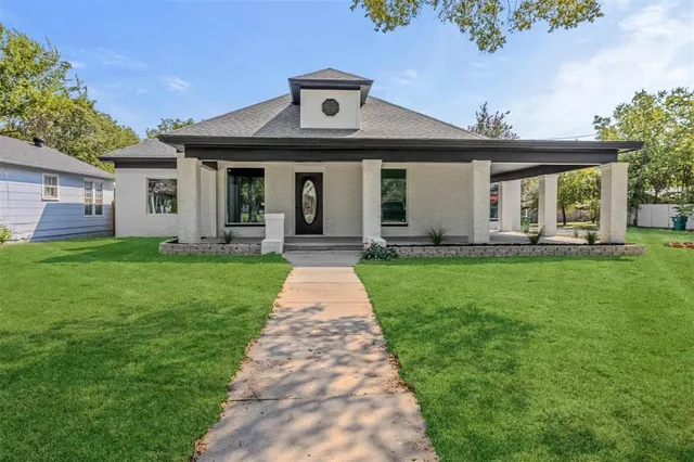 a front view of a house with a yard and porch