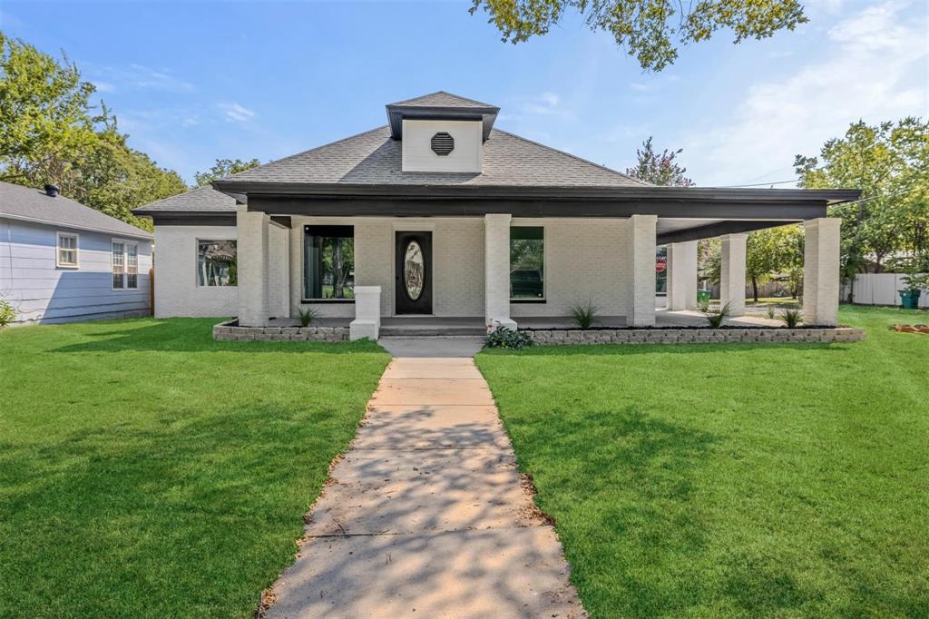 700 North Church Street Decatur, TX 76234 - Photo 5 of 15 a front view of a house with a yard and porch