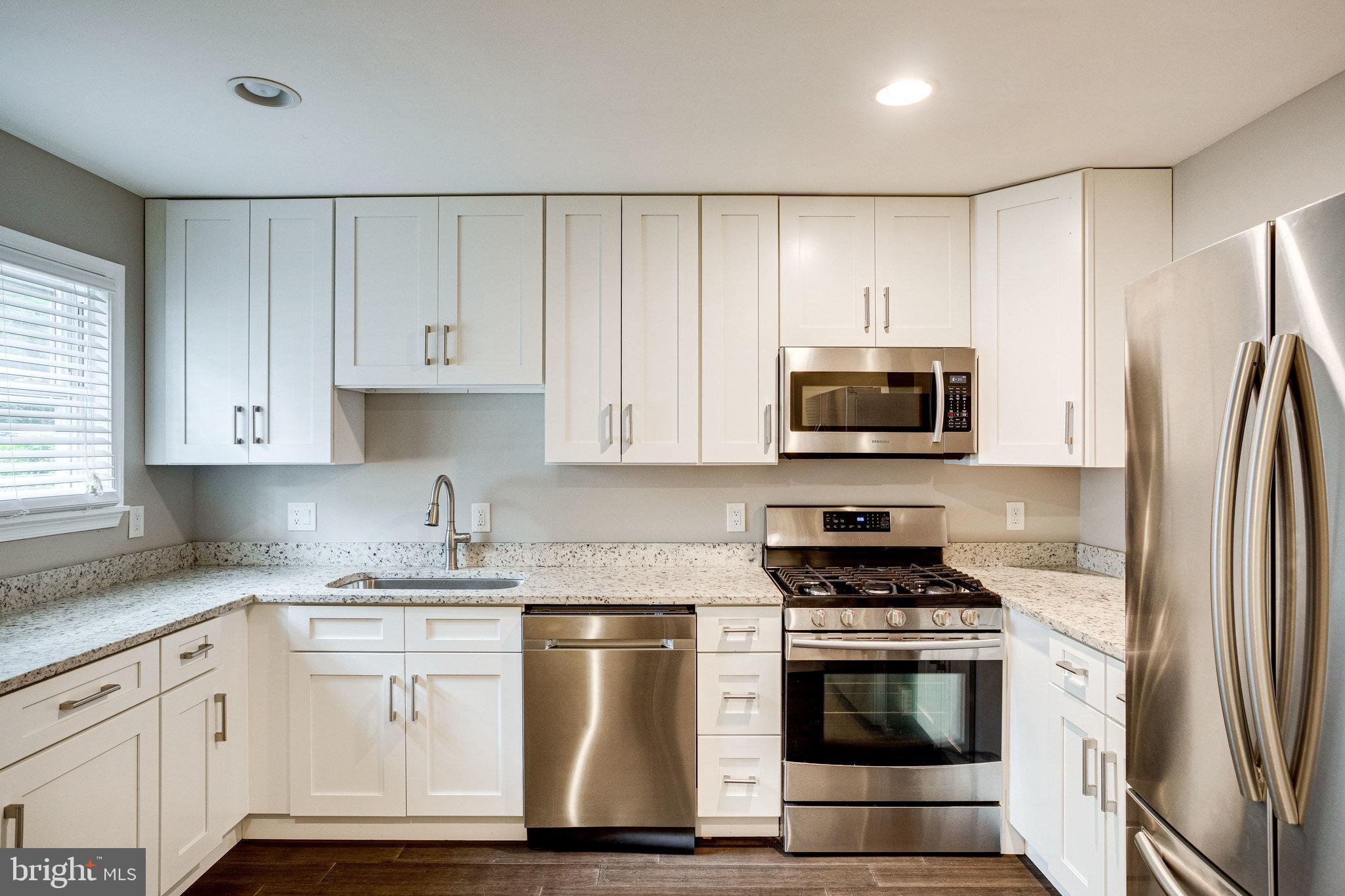 2648 Bowen Road Southeast Washington, DC 20020 - Photo 10 of 36 a kitchen with stainless steel appliances a stove a sink and a refrigerator