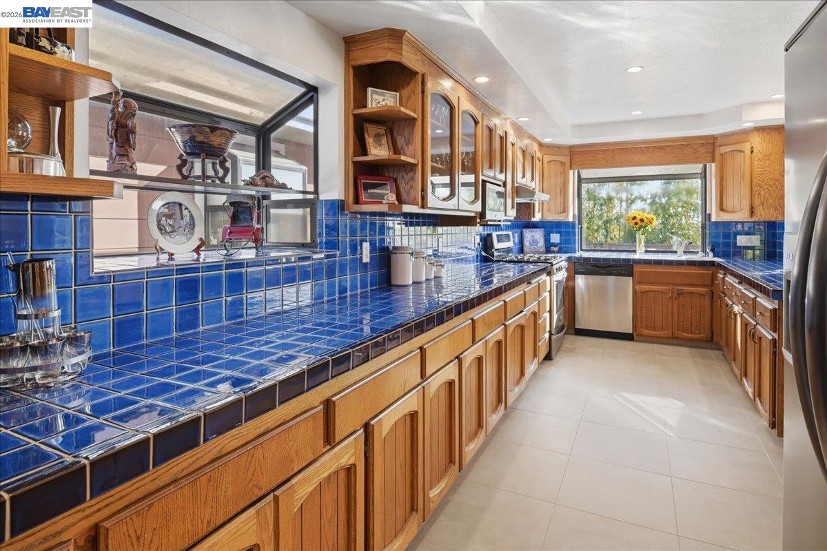 22111 Prospect Street Hayward, CA 94541 - Photo 27 of 70 Galley kitchen has stainless steel appliances, pass thru counter to dining room, gas stove, recessed lighting, garden windows
