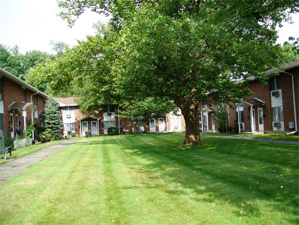 1078 Allen Street, Unit F Springfield, MA 01118 - Photo 23 of 23 a brick house with trees in front of it