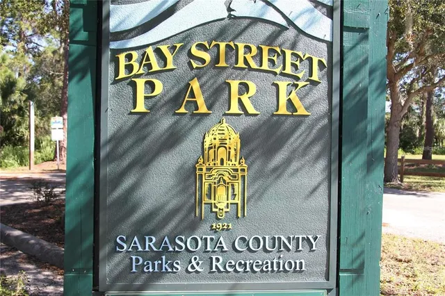 a view of a chairs and table under an umbrella in backyard