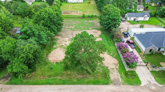 an aerial view of residential house with outdoor space and trees all around