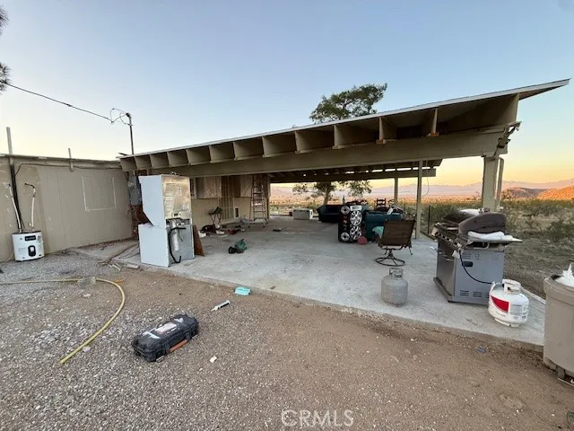 a view of a house with a backyard and a tree