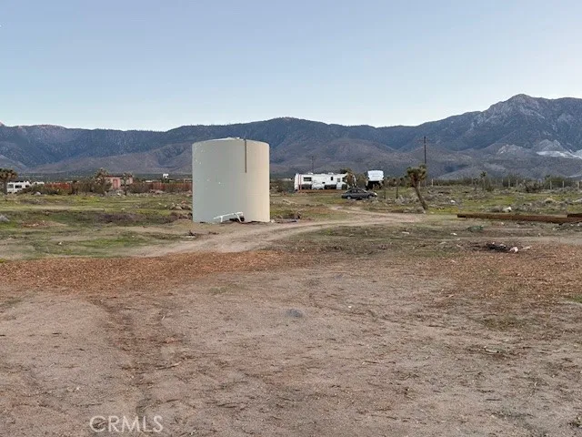 a backyard of a house with barbeque oven table and chairs