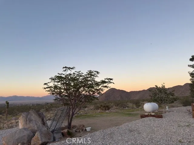 a view of a field with an ocean view