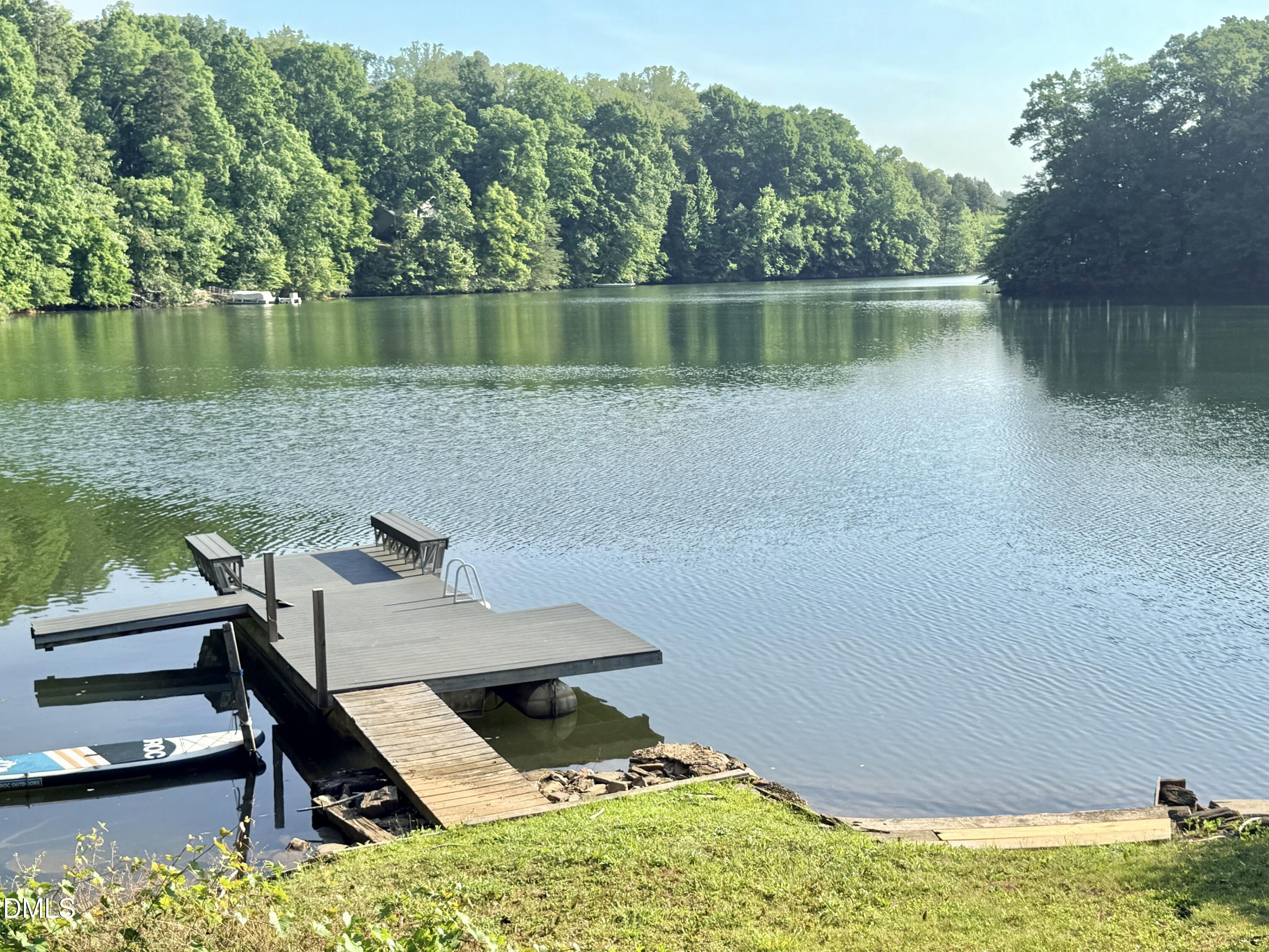 81 Beaver Crossing Road Roxboro, NC 27574 - Photo 75 of 80 a view of a lake with table and chairs