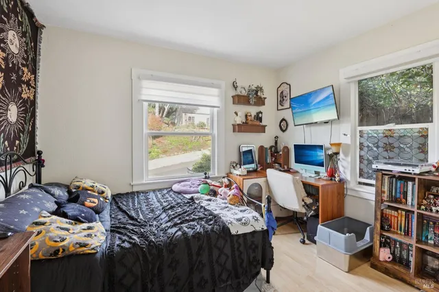 a bedroom with a bed and a window
