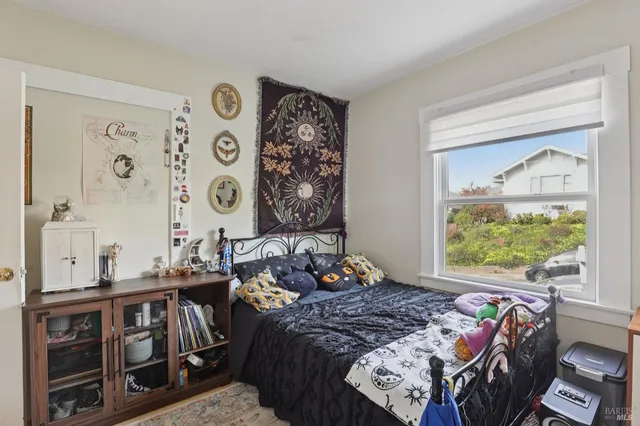 a bed sitting in a bedroom next to a window