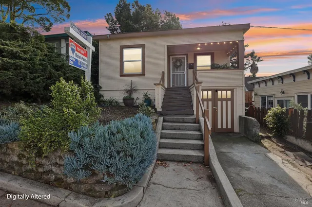 a view of a house with backyard and sitting area